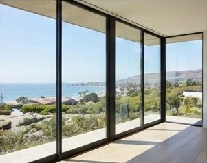 Floor to ceiling sliding glass wall with ocean view